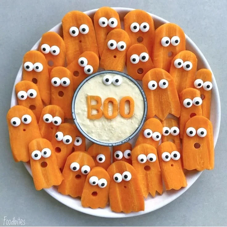 Colorful Halloween veggie tray with spooky shapes and eyes for kids' snacks