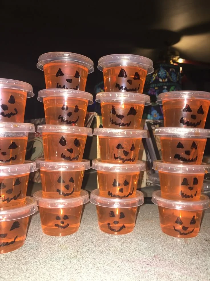 Colorful Halloween-themed Jell-O shots in spooky cups