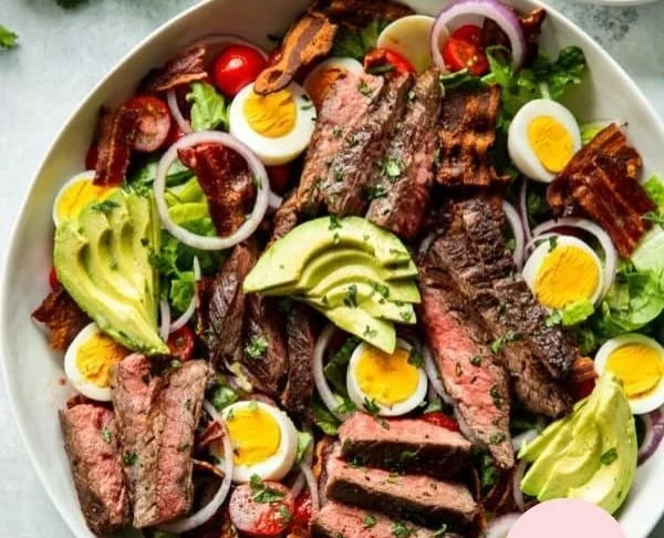 Keto Steak Cobb Salad topped with creamy avocado dressing and fresh ingredients.