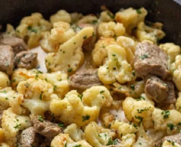 Low carb creamy steak bites with cauliflower in a skillet for dinner