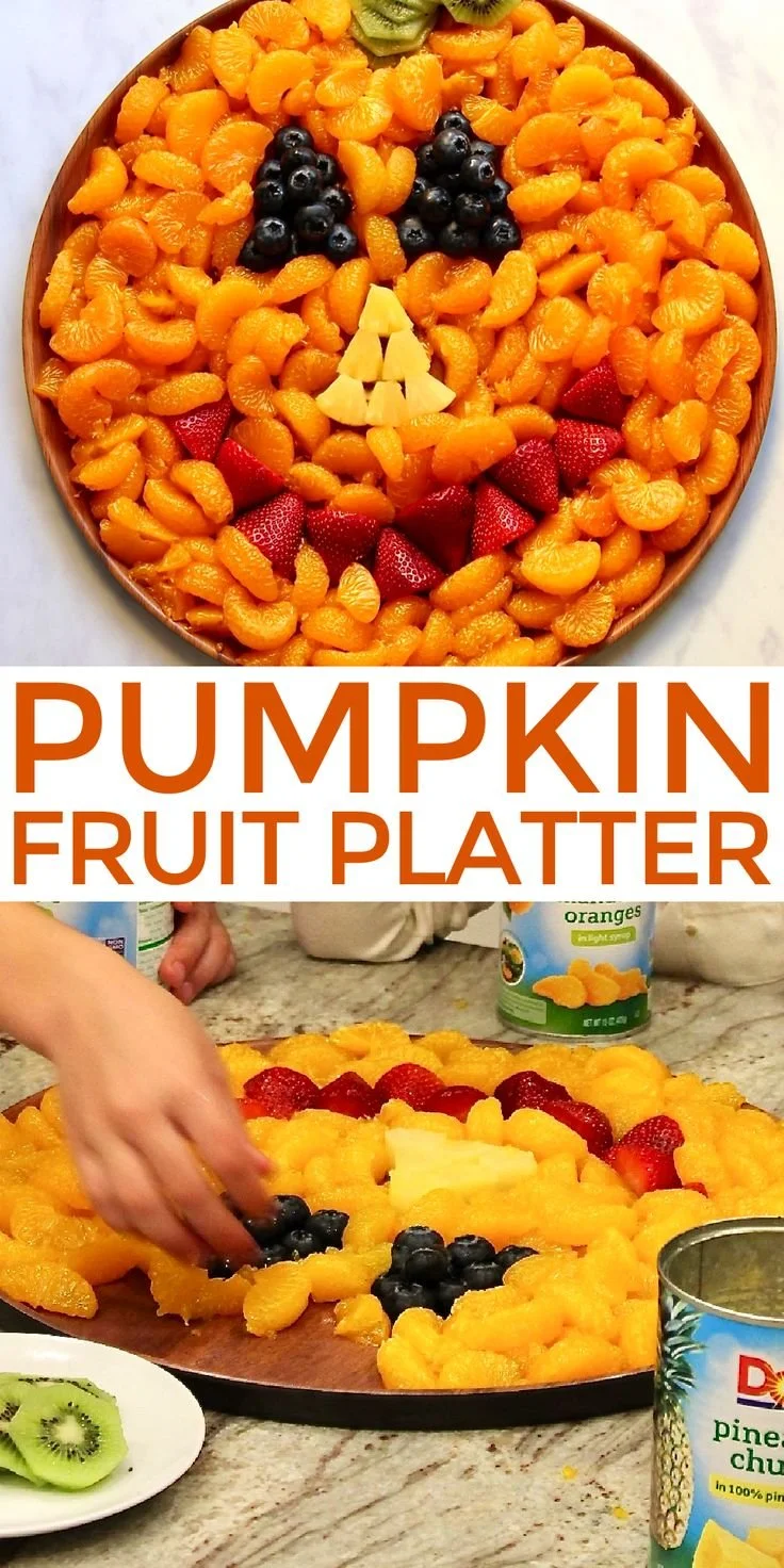 Colorful pumpkin fruit platter arranged with seasonal fruits and festive decorations.