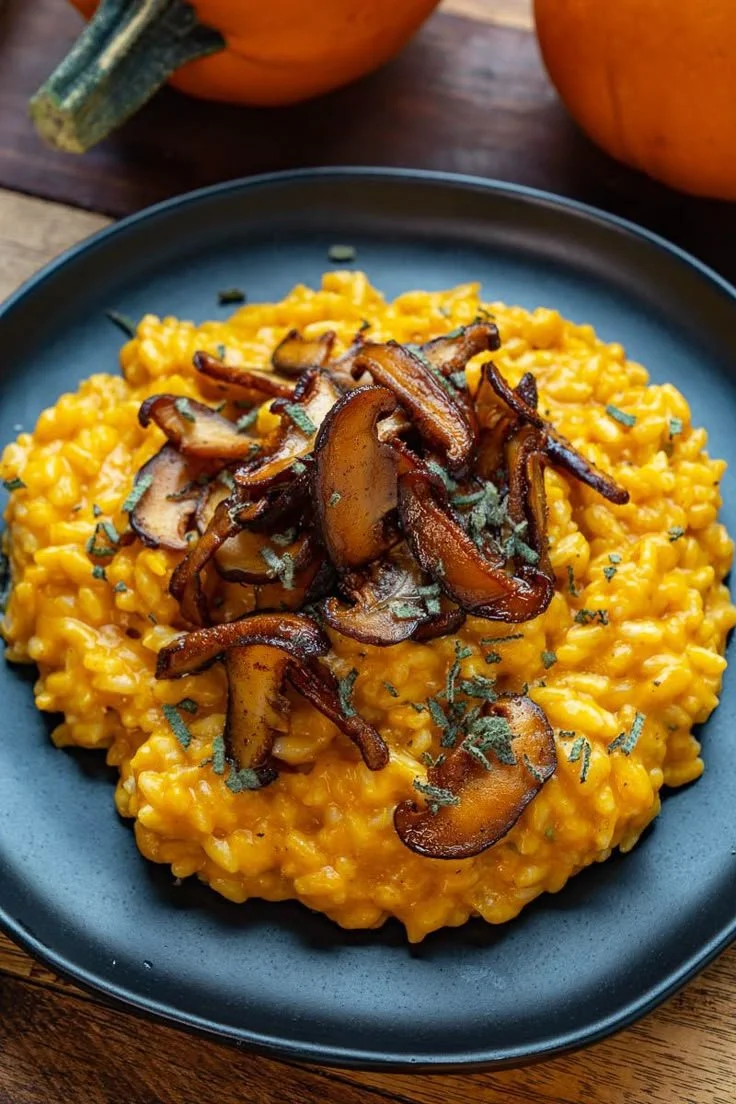 Creamy pumpkin risotto garnished with herbs and cheese