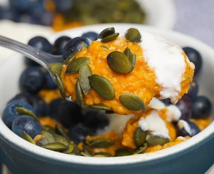 Healthy sweet potato breakfast bowl topped with fruits and nuts