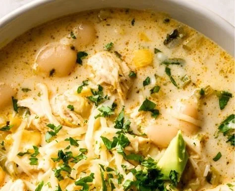 Delicious bowl of white chicken chili served with toppings